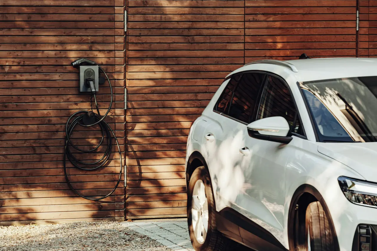 Electric car beside a wall charger