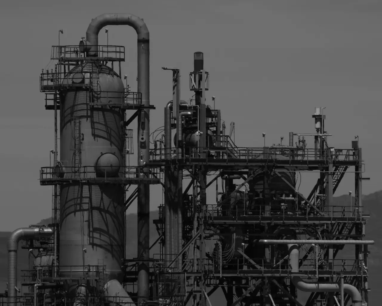 Refinery towers in black and white